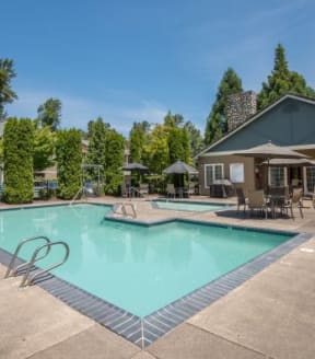 Valley River Court swimming pool and tables with umbrellas