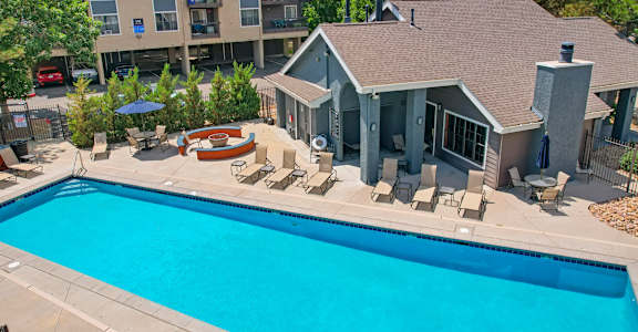 an aerial view of a swimming pool and a house with a pool