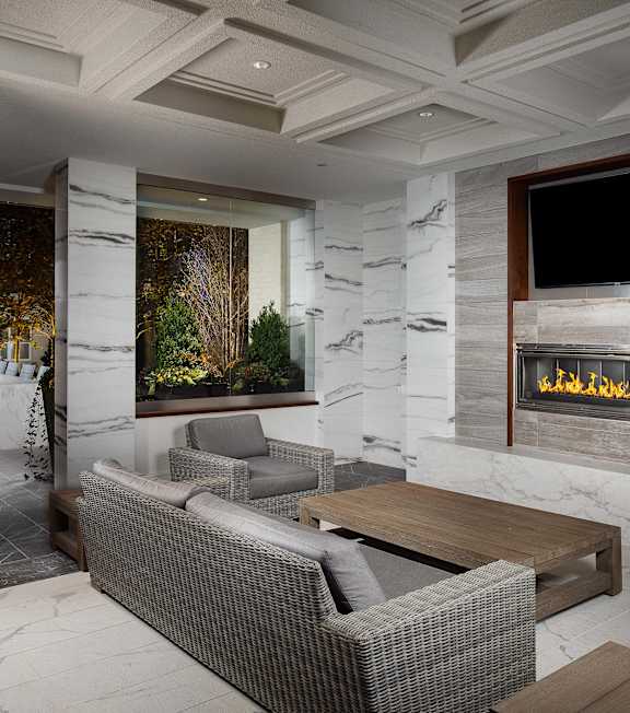 A modern living room with a fireplace and a flat screen TV.