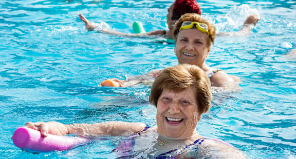 a group of women swimming in a swimming pool
