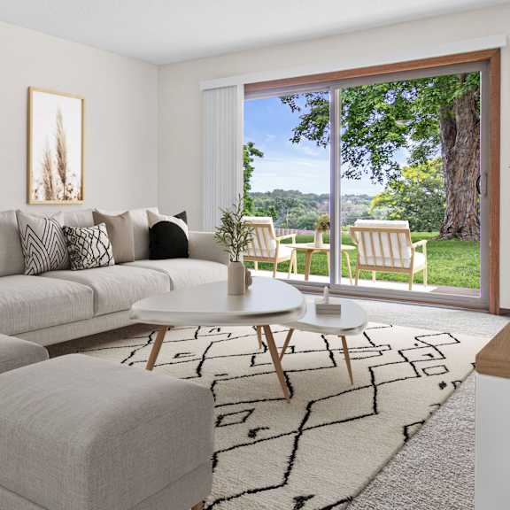A living room with a grey rug and a white sofa.