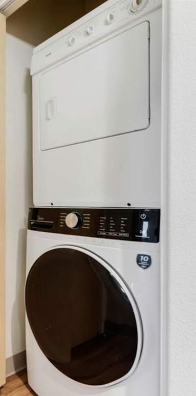 A white dryer is in a small room.