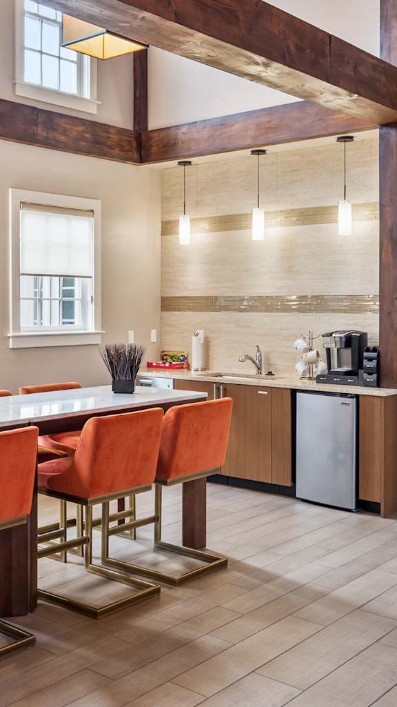 A kitchen with a sink and a refrigerator.