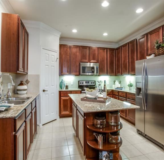 Gourmet Kitchen with Breakfast Bar and Pantry at Orion Prosper Lakes in Prosper, TX