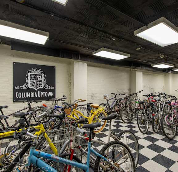A bike parking area with a sign that says Columbia Uptown. at Columbia Uptown Apartments, Washington, 20009