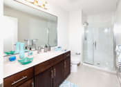 Thumbnail 4 of 24 - Modern bathroom with dual vanity and teal accent pieces