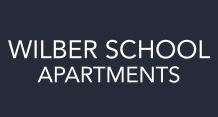 navy and white logo of Wilber School Apartments, Massachusetts, 02067