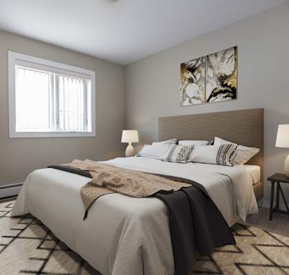 a bedroom with a large bed and a window