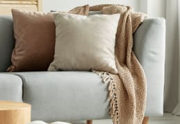 a living room with a couch and pillows on it