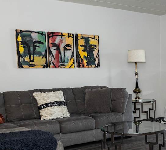 a living room with hardwood floors and a sliding glass door leading to a balcony at Walnut Crossings in Monroeville, PA 15146
