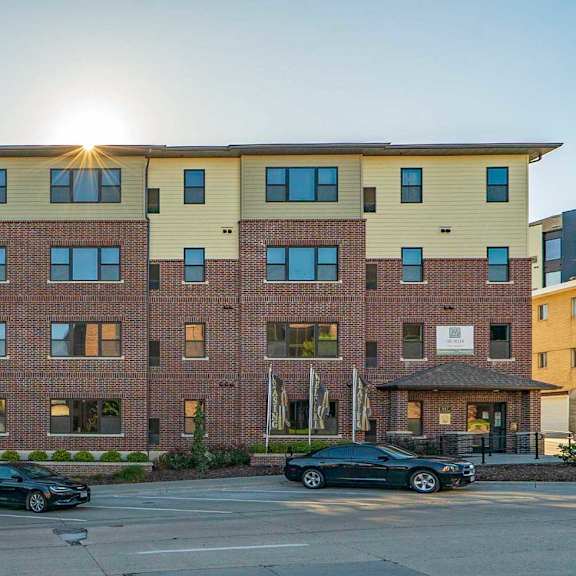  The Helen apartment building exterior with street parking