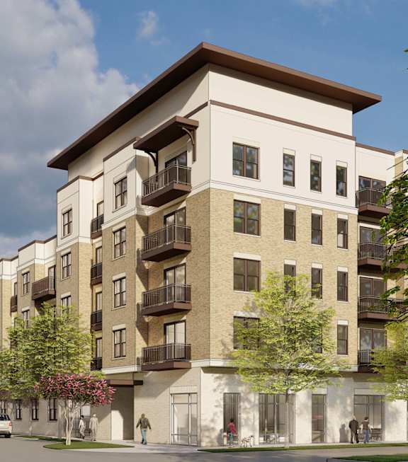 A large apartment building with a parking lot in front.