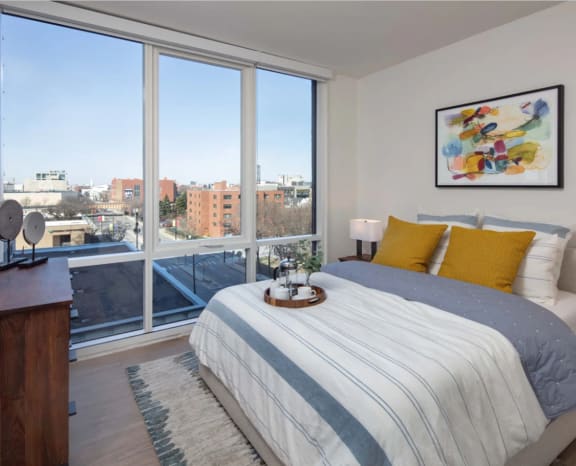 Cozy Bedroom with View of Chicago from Floor to Ceiling Windows at North&#x2B;Vine in Chicago, Illinois 60610