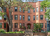 Thumbnail 43 of 67 - a red brick building with trees in front of it