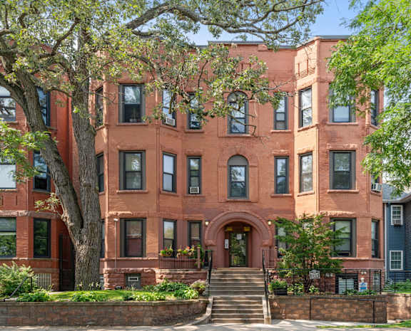 a red brick building with trees in front of it