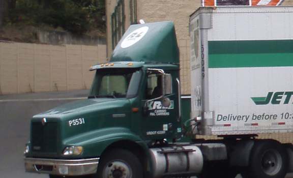 A woman is walking towards a storage unit entrance.