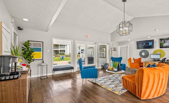 A living room with a blue chair and an orange chair.
