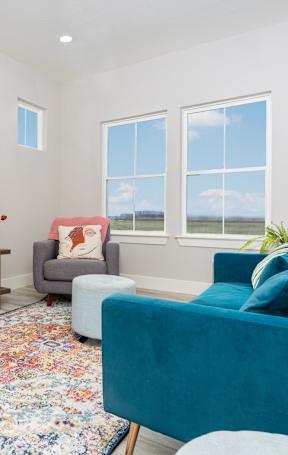a living room with blue furniture and a tv at Mihir Taylor, Taylor, 76574