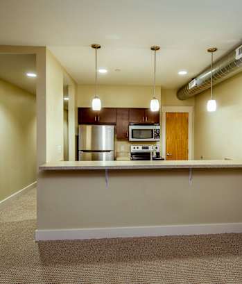 A kitchen area with a counter and a stove.