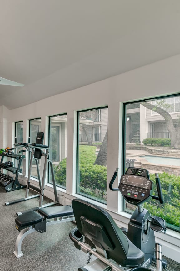 a gym with weights and cardio machines in it
