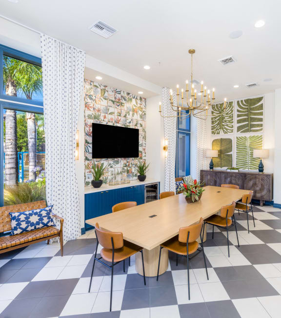 the dining room has a checkered floor and a long table with chairs