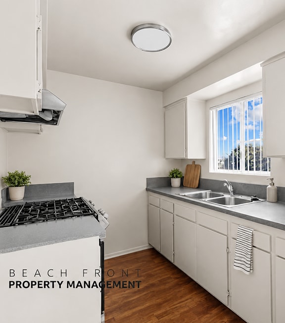A well-lit, modern kitchen and living room with a dining area.