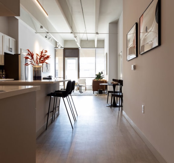 a kitchen and a living room with a table and chairs at The Residences at Tesson Ridge, Saint Louis, 63128