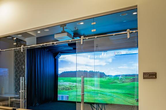 A pool table in a room with a view of a golf course.
