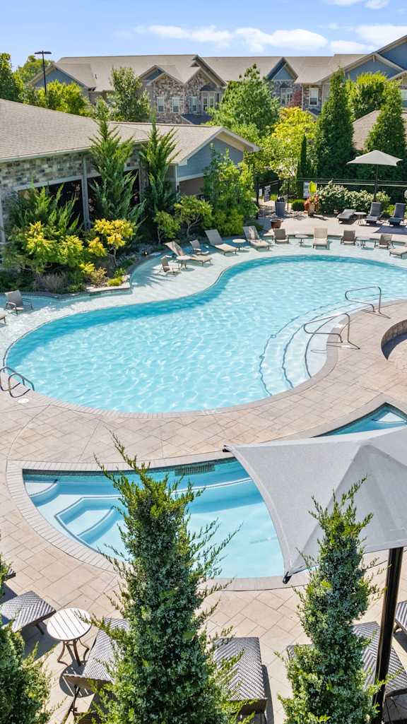 An aerial view of the pool and landscaping at Stonepost Crossing Apartment Homes in Overland Park, Kansas.
