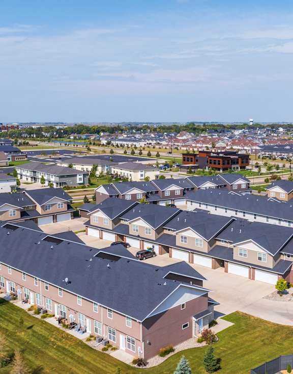 A large housing development with multiple houses and a clear sky.