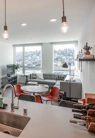 A modern kitchen with a large island and pendant lights.at Axle, Seattle Washington