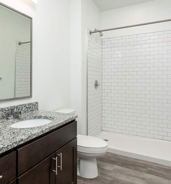 A bathroom with a white sink and a white toilet.