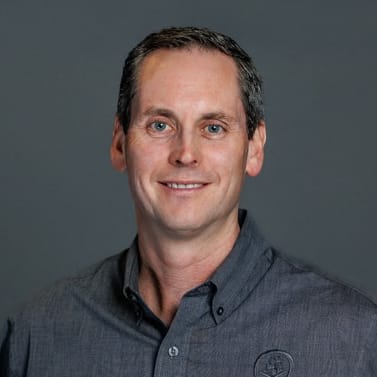 a man in a grey shirt and a gray background