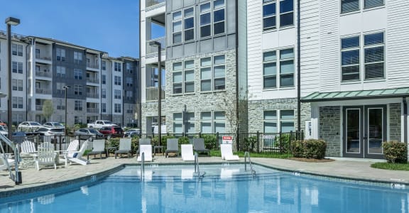 a large swimming pool in front of a building