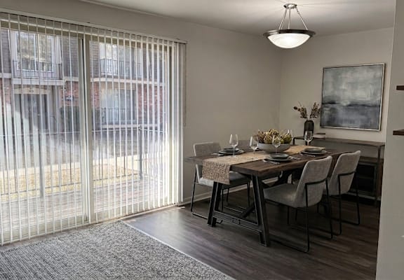 A dining room with a table set for four.