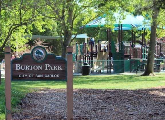 a sign in front of a playground