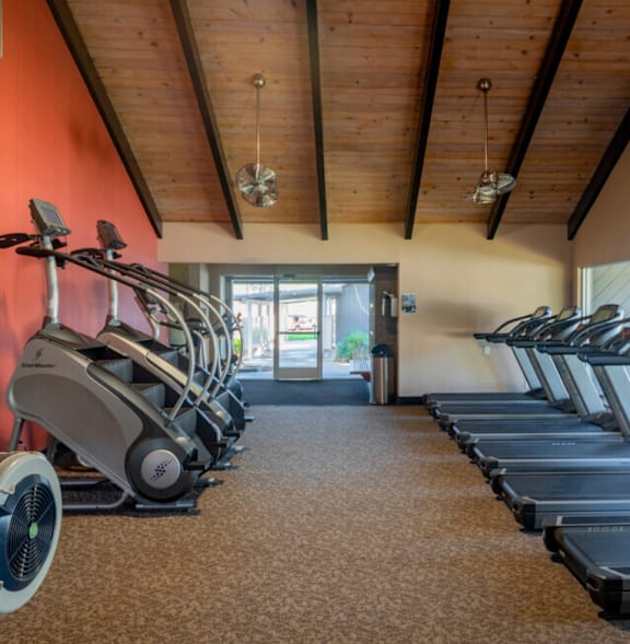 A gym with treadmills and elliptical machines at Cherrywood Apartments, San Jose, CA, 95118