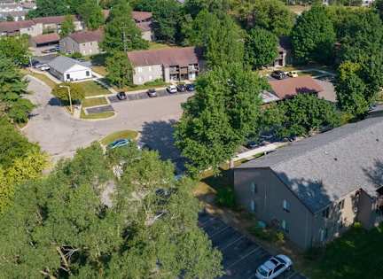 A bird's eye view of a residential area with houses and trees.