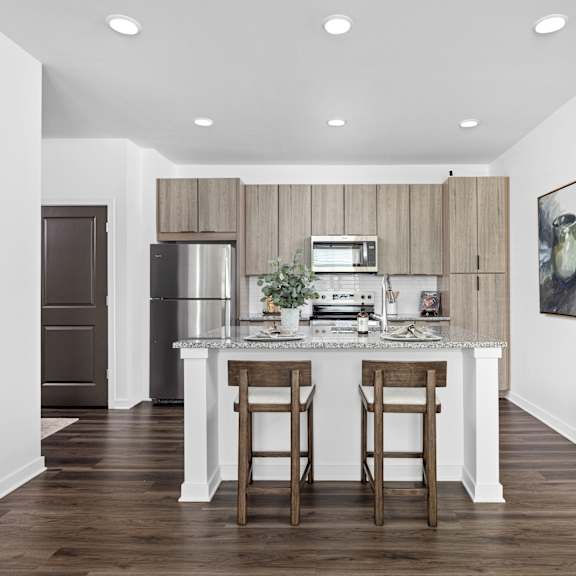 the kitchen is open to the living room and dining room at The Pullman Luxury Apartments, Atlanta, GA, 30349