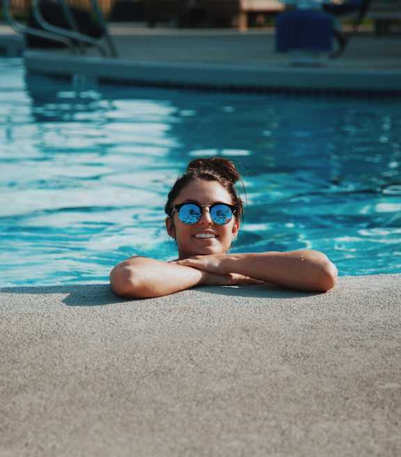 A person is relaxing by the poolside.