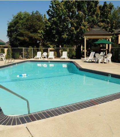Todd Village swimming pool and furniture at Todd Village Apartments, Oregon