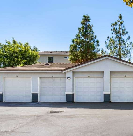 A two-story house with a garage and a driveway.