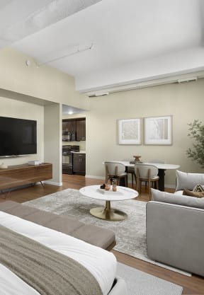 an open kitchen and living room with a black island and white cabinets