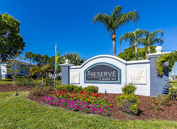 A sign that says "Preserve" in front of a building.
