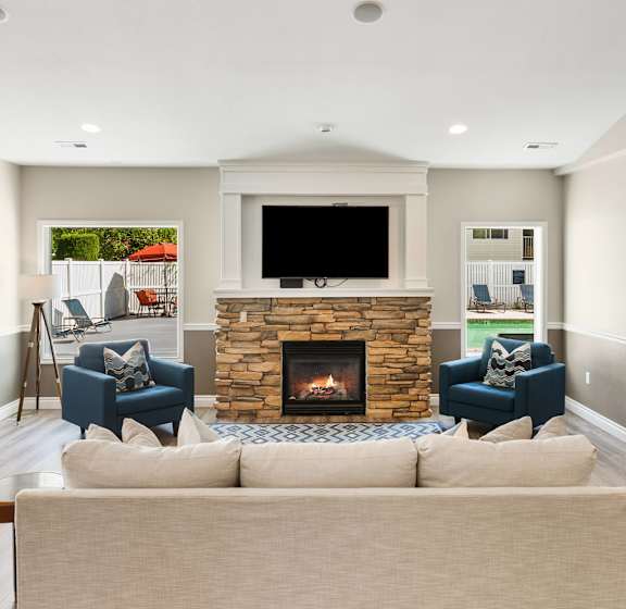 a living room with a couch and a fireplace at Sage Apartments, Everett, Washington