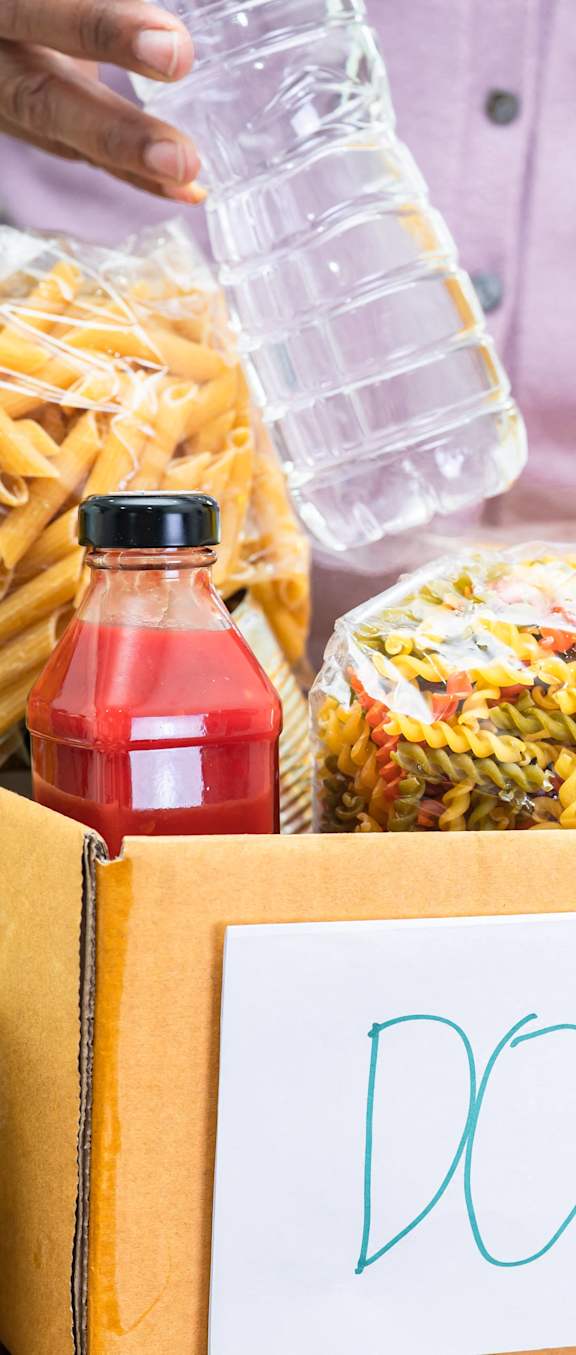 a box of food on a table with a donation sign