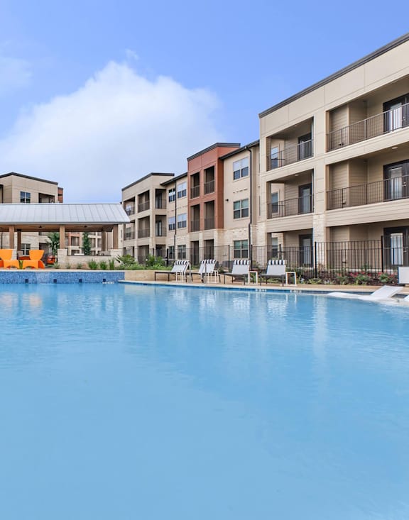 A large swimming pool in front of apartment buildings. at Sienna at Westover Hills Apartments, San Antonio, TX 78253