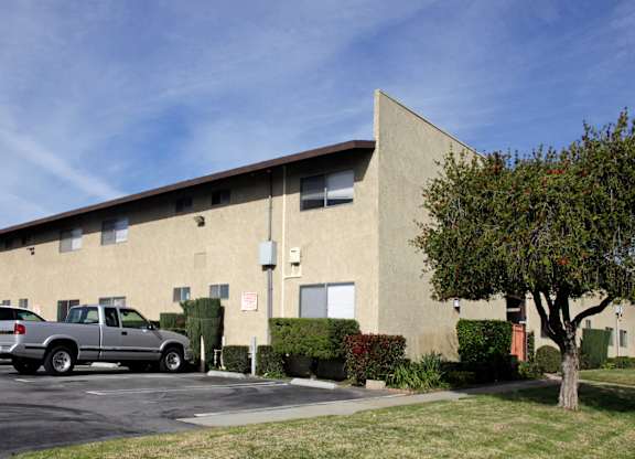 A building with a parking lot in front of it.