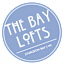 A blue circular logo with the text "The Bay Lofts" and "Sturgeon Bay WI" on it.