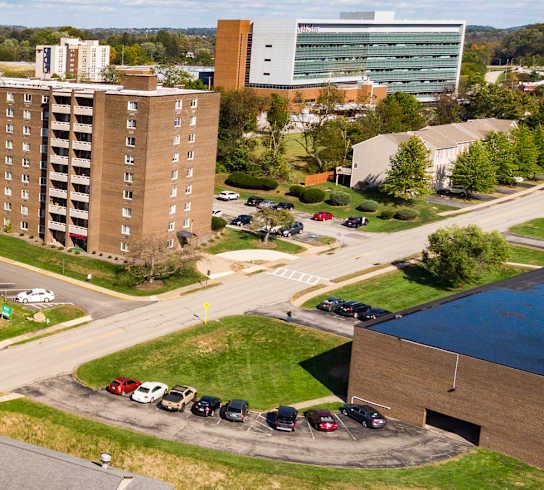 a view from the top of a building of a street with cars parked on the side of at Walnut Crossings in Monroeville, PA 15146
